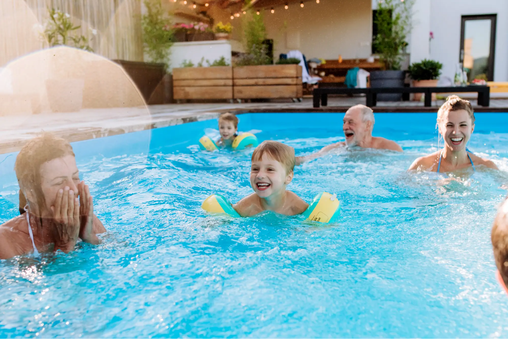 Family in pool, kids with floaties