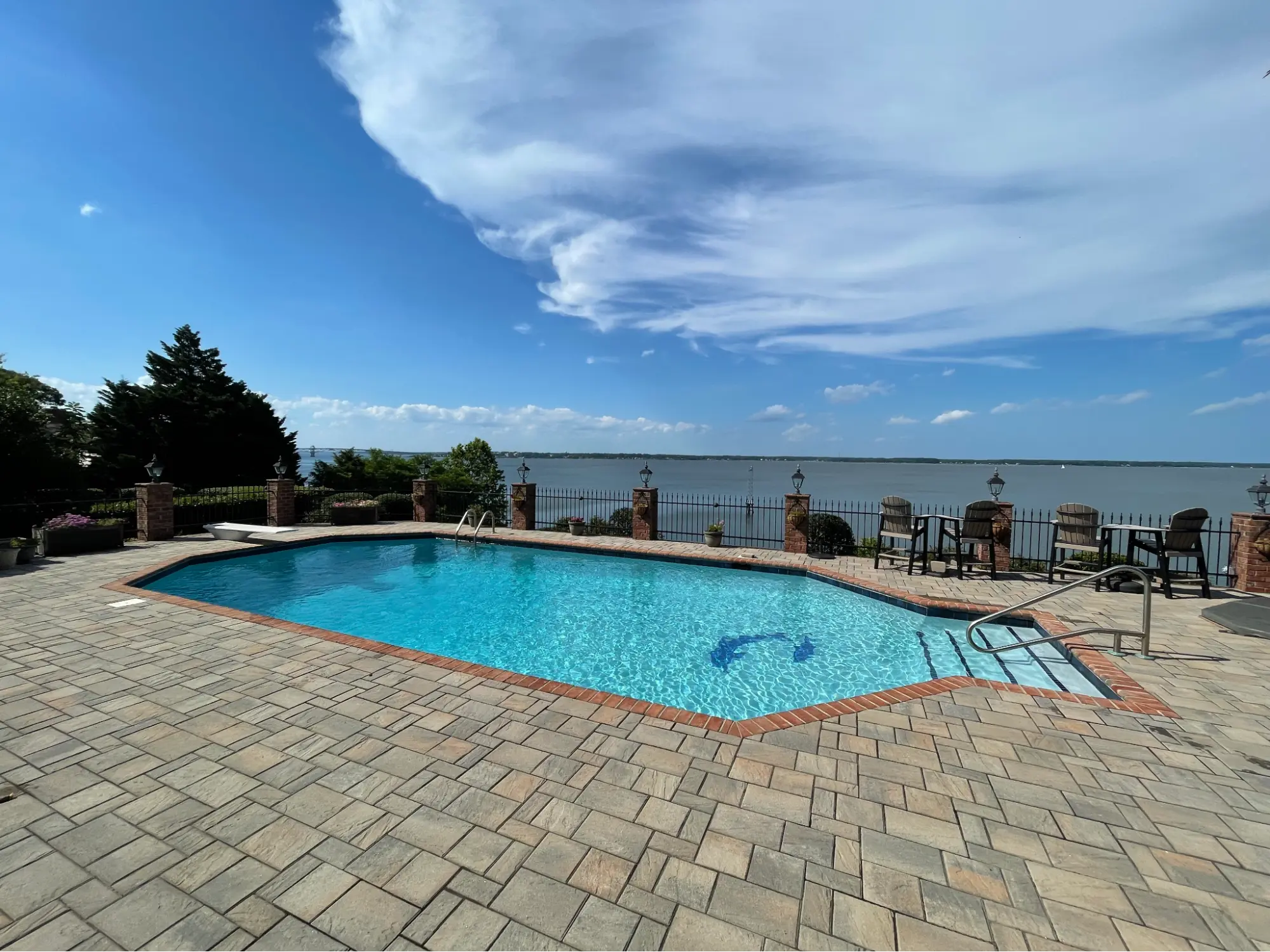 Swimming pool with lake in background