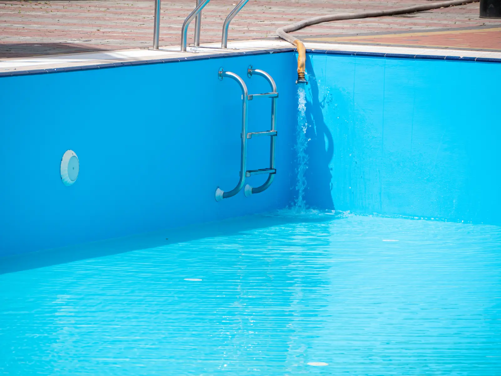 Pouring fresh water into swimming pool after repair